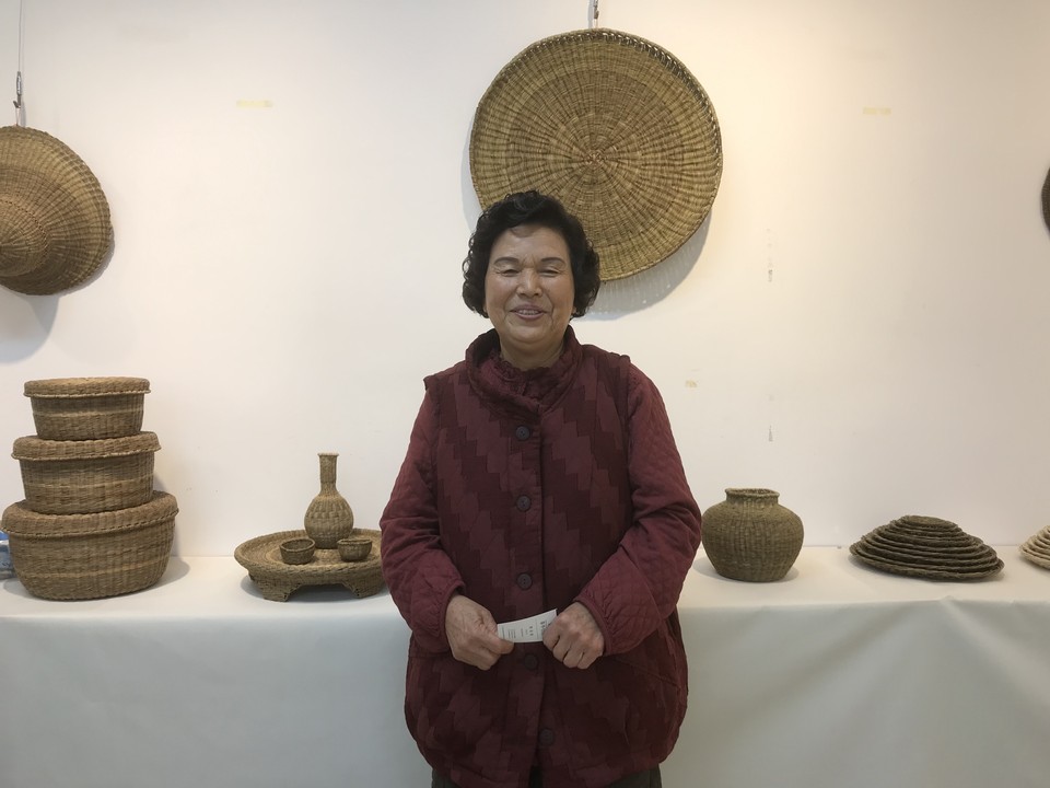 댕댕이장 백길자 씨가 홍성문화원 2층 전시실에서 전시중인 자신의 작품들 앞에서 관람객들을 맞이하고 있다.