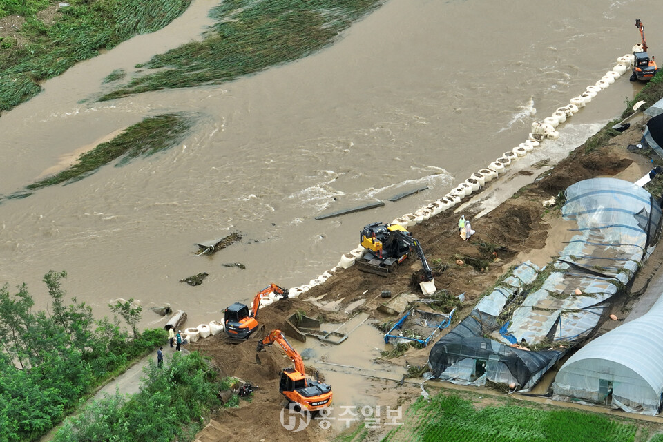 집중호우로 제방이 붕괴된 홍성군 갈산면 와룡천 긴급 복구 작업현장.<br>